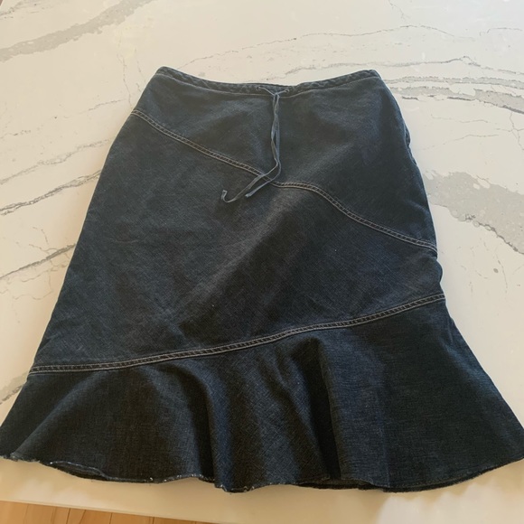 Super Cute Jean skirt with tie in the front. Zipper on the side. Some stretch. - Picture 1 of 4